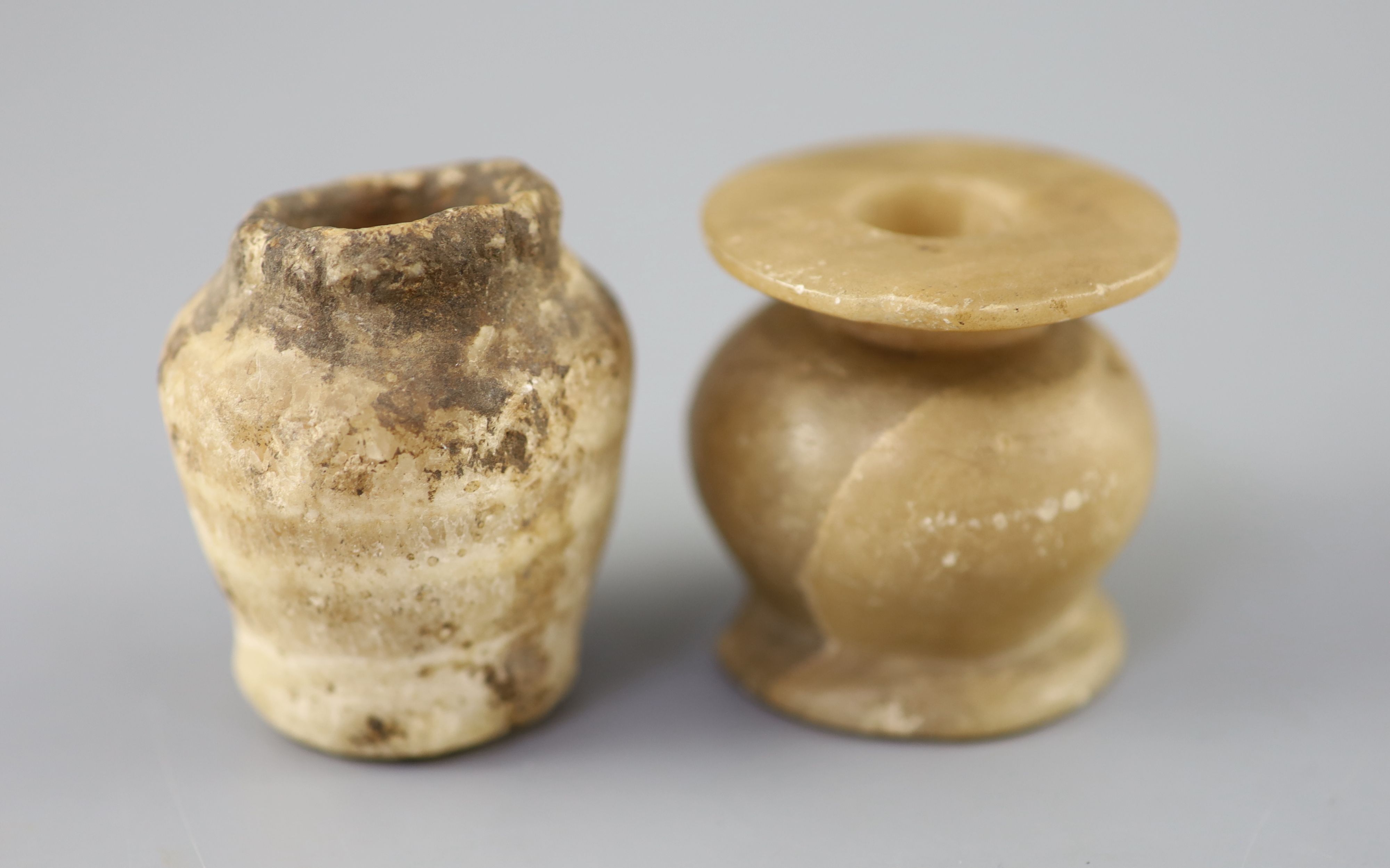 Two Egyptian alabaster cosmetic jars, c.1500 BC and Ptolemaic period (305-30 BC), Provenance - A. T. Arber-Cooke